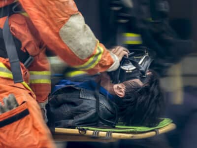 Running blurry paramedic carrying patient on stretcher